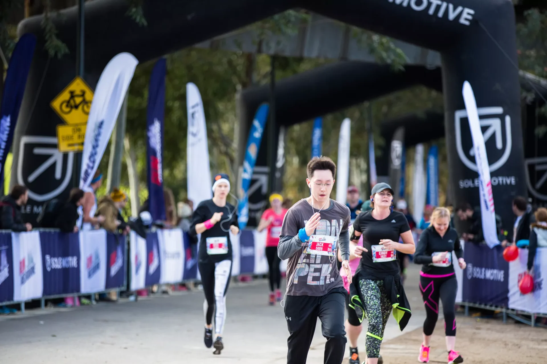 Runners crossing an event archway during a Melbourne race